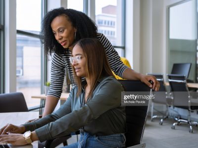 Woman mentoring a young employee in the office